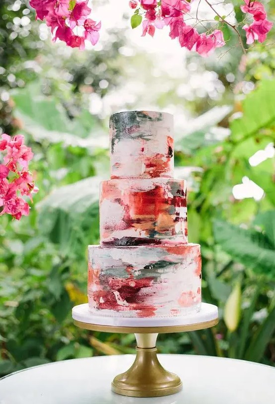 a super bold brushstroke wedding cake in green, burgundy, red and orange for a colorful summer wedding