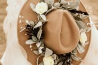 a tan bridal hat with neutral blooms and pale foliage is a chic and cool idea for a boho or garden bride
