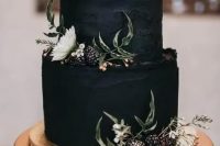 a textural black wedding cake with a raw edge, gilded blackberries and white blooms is a gorgeous idea for a modern and moody wedding