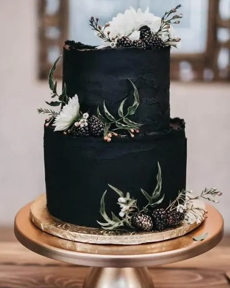 a textural black wedding cake with a raw edge, gilded blackberries and white blooms is a gorgeous idea for a modern and moody wedding