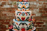 a traditional bright floral Mexican wedding cake – these sugar blooms are 3D ones, and there are matching fresh flowers