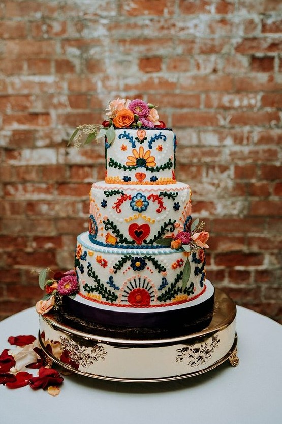 a traditional bright floral Mexican wedding cake - these sugar blooms are 3D ones, and there are matching fresh flowers