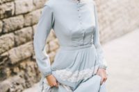 a vintage-inspired powder blue wedding dress with buttons, long sleeves and white lace