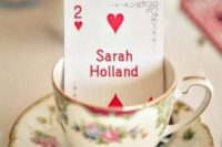 a vintage teacup with an escort card to mark each place setting – great for Alice In Wonderland wedding