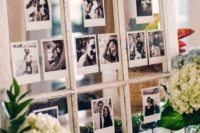 a wedding decoration of a vintage window with black and white Polaroids of the couple
