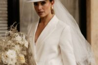 a white hat with a long veil is a trendy and modern solution for a bride that feels like 90s