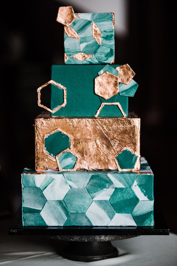 an emerald and gold squre wedding cake with green marble hexagons, a gold foil tier, emerald and gold hexagons is amazing