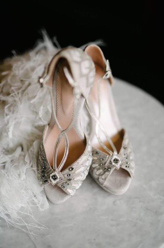 bold art deco wedding shoes in off-white, with embellishments and thin straps look really wow