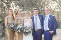 groomsmen wearing navy suits and light-colored ties, bridesmaids wearing gold glitter maxi dresses