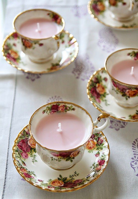 lovely floral teacups with candles inside can hold your escort cards and become chic wedding favors