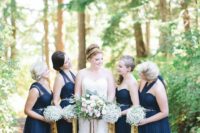 navy maxi bridesmaid dresses with baby’s breath bouquets and gold ribbons