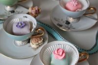 pastel teacups with pastel petit fours are great wedding favors and they can hold your escort cards, too
