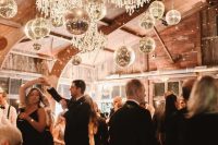 a barn dancing floor lit up with crystal chandelirs and disco balls is amazing, it will feel like party all the time