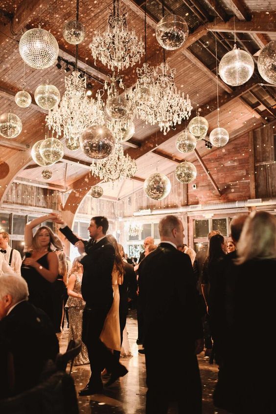 a barn dancing floor lit up with crystal chandelirs and disco balls is amazing, it will feel like party all the time