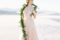 a blush spaghetti strap draped wedding gown with an A-line skirt, sheer cap sleeves and a draped bodice