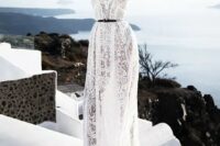 a boho lace wedding gown accented with a thin black belt for a more modern feel