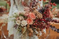 a bold fall ombre wedding bouquet from white to deep purple, with blush, mauve, pink and burgundy blooms and dried greenery