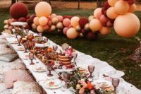 a cool wedding picnic with a grazing table