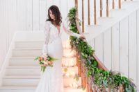 a catchy boho lace mermaid wedding dress with bell sleeves, an illusion bodice with a plunging neckline and a train