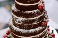 a chocolate naked wedding cake topped with fresh berries is a delicious and cool idea for a summer wedding