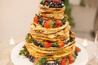 a crepe wedding cake topped with fresh berries and with cream and caramel is a fantastic idea for a summer wedding