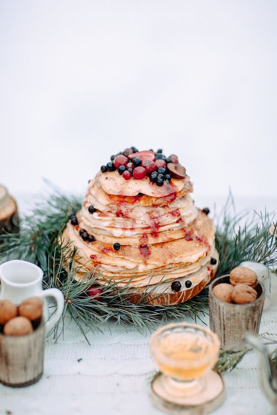 a crepe wedding cake with berry sauce and fresh berries and fruit on top is a lovely idea for a decadent fall wedding