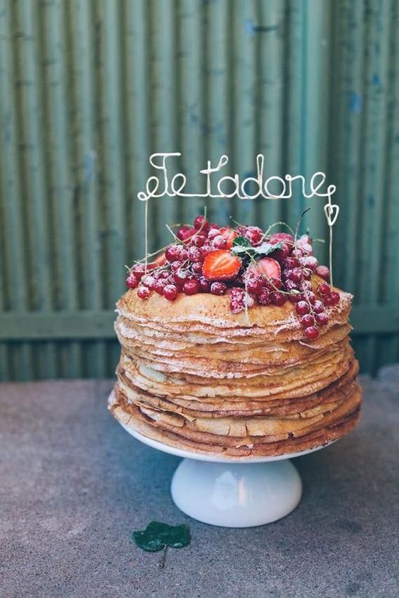 a crepe wedding cake with lots of fresh berries and a wire cake topper is a fantastic idea for a summer wedding
