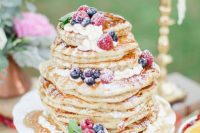 a delicious pancake wedding cake with whipped cream and fresh berries and sugar powder is a fantastic dessert to DIY