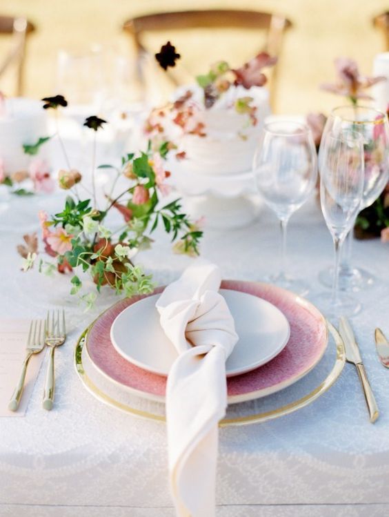 a dreamy garden shower setting with a a sheer platter, a pink plate, gold flatware and delicate greenery and leaves for a summer to fall shower