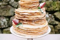 a fab crepe wedding cake topped with fresh strawberries, sugar powder and mint is a gorgeous idea for a summer wedding