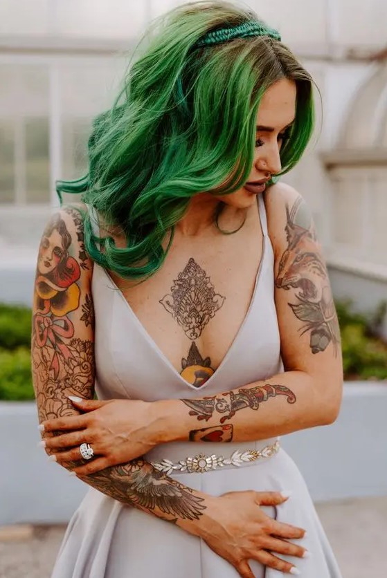 a fantastic rock n roll bridal look with a romantic grey A-line wedding dress, an embellished sash, tattoos shown off and green hair