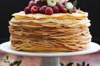 a gorgeous crepe wedding cake topped with fresh berries and white blooms is a lovely idea for a summer wedding