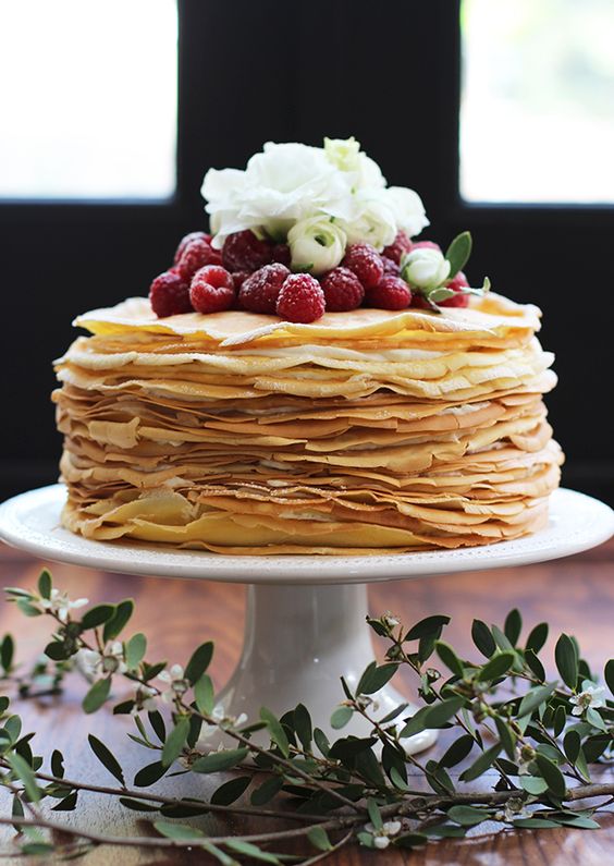 a gorgeous crepe wedding cake topped with fresh berries and white blooms is a lovely idea for a summer wedding