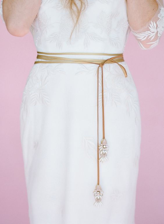 a leather sash with catchy pink and white opal crystals is a lovely addition to a boho bridal look
