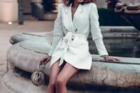a little white tux dress with contrasting buttons, white strappy heels and statement earrings for a trendy look