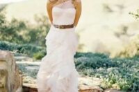 a lovely blush wedding gown accented with a brown leather belt for a slight rustic feel