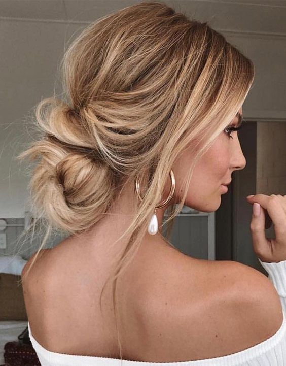 a lovely messy and wavy low updo with a volume on top, some locks down and a twisted low bun is a gorgeous idea for a modern bride