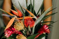 a modern tropical wedding bouquet of pincushion proteas, some other tropical blooms and foliage is a lovely idea