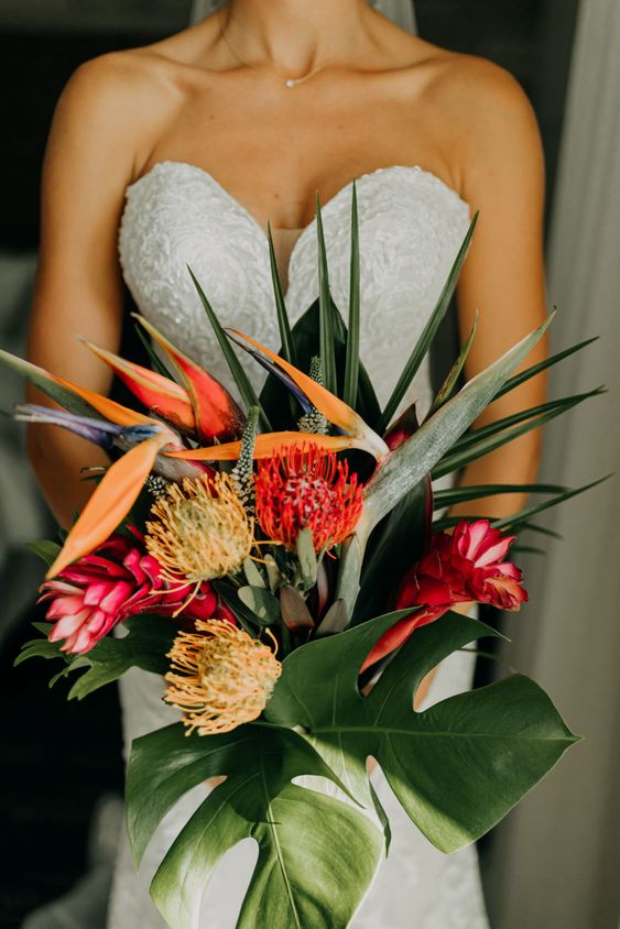 a modern tropical wedding bouquet of pincushion proteas, some other tropical blooms and foliage is a lovely idea
