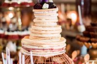 a pancake wedding cake with berry sauce and fresh berries and blooms on top is a fantastic idea to rock