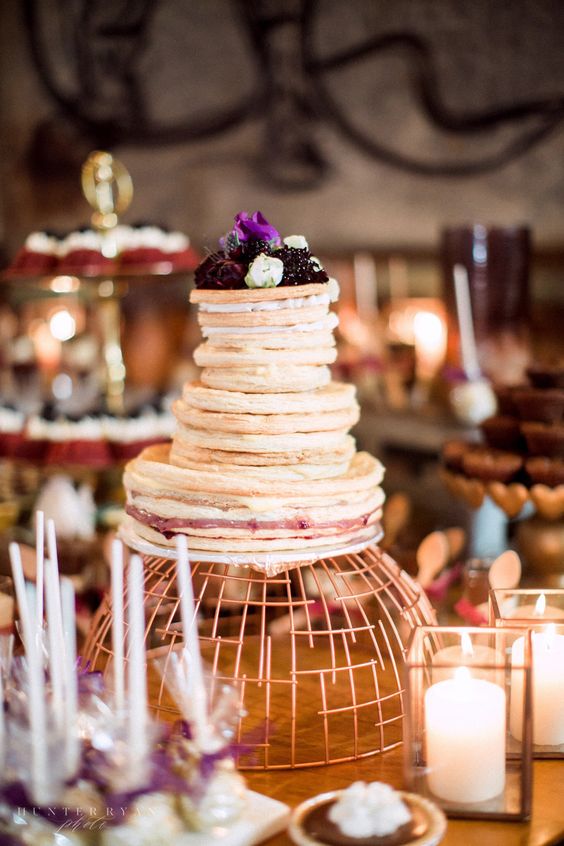 a pancake wedding cake with berry sauce and fresh berries and blooms on top is a fantastic idea to rock