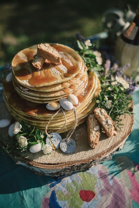 a pancake wedding cake with caramel, candy pebbles, greenery and bread with nuts is a lovely idea for a rustic wedding