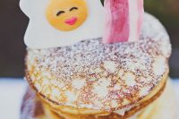 a pancake wedding cake with sugar powder topped with a candy fried egg and a slice of bacon is amazing for a brunch wedding