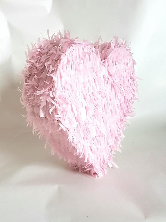 a pink fringe heart-shaped pinata is a very pretty and lovely idea with a touch of romance is a cool wedding guest book