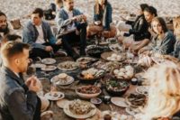 a relaxed beach boho wedding picnic with blankets, lots of delicious food and laid-back vibes