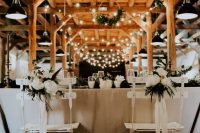 a rustic wedding venue with string lights and retro pendant lamps is a lovely idea for a rustic or boho wedding