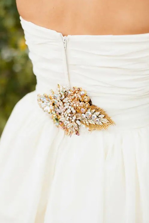 a sash with an oversized gold leaf done with crystals of various kinds is a fantastic idea for a vintage glam bride