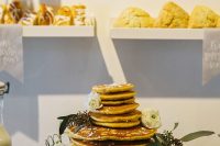 a simple pancake wedding cake with honey and topped with fresh white blooms and greenery is a gorgeous idea
