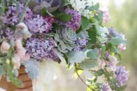a super lush and catchy wedding bouquet of lilac and white lilac, lots of greenery, pale leaves, succulents is a lovely idea for a spring bride