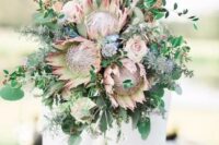 a wedding bouquet with king proteas, eucalyptus and greenery for a boho bride